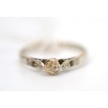 A diamond solitaire ring with rose cut diamond shoulders, stamped '18ct' and 'pt' (marks