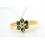 An 18ct gold diamond and green stone cluster ring