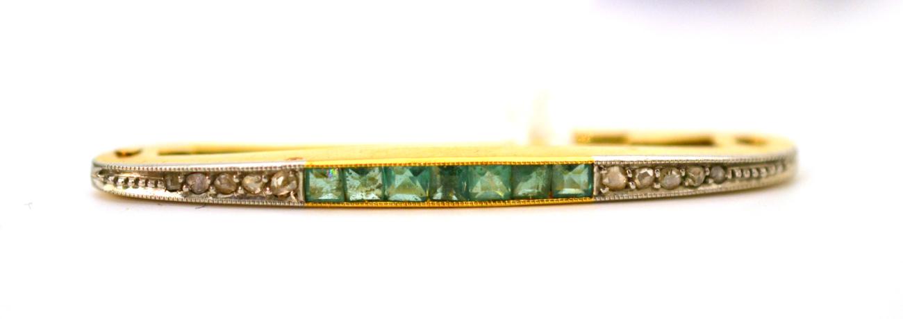 An emerald and diamond bar brooch