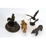 A bronze cockerel group, a bronze bear, a gold painted figure and a bird on barbed wire