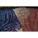 A 19th century woven paisley shawl with cream centre and length of blue brocade fabric woven with