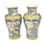 Pair of 19th century famille rose yellow ground baluster vases, 34cm high