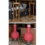 A pair of metal table lamps of cluster column form and a pair of sang de beouf style lamps, all with