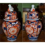 Pair of large Imari pottery vases and covers Height including cover - 46cm high. Firing crack to the