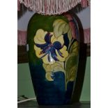 A Moorcroft Hibiscus pattern table lamp and shade  Lamp base - 34cm high. Some crazing and slight