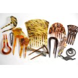 A collection of mainly faux tortoiseshell hair combs and clips, including two pierced examples,