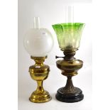 Two gilt metal oil lamps, one with a Victorian green acid etched shade, the other with an opaque