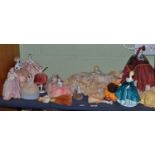 A shelf including a Continental pin cushion, lamp shade, crumb brush, dolls with ceramic torsos