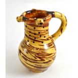 A puzzle jug, 19cm high Firing crack to the base and top of the handle, hairline crack to the