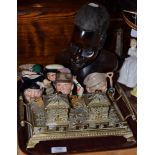 Decorative brass inkstand, five Royal Doulton small character jugs and a carved ethnographic head