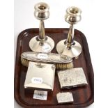 A pair of silver candlesticks, a silver vesta, a cigarette case, a cigarette box and brush  6.2ozt