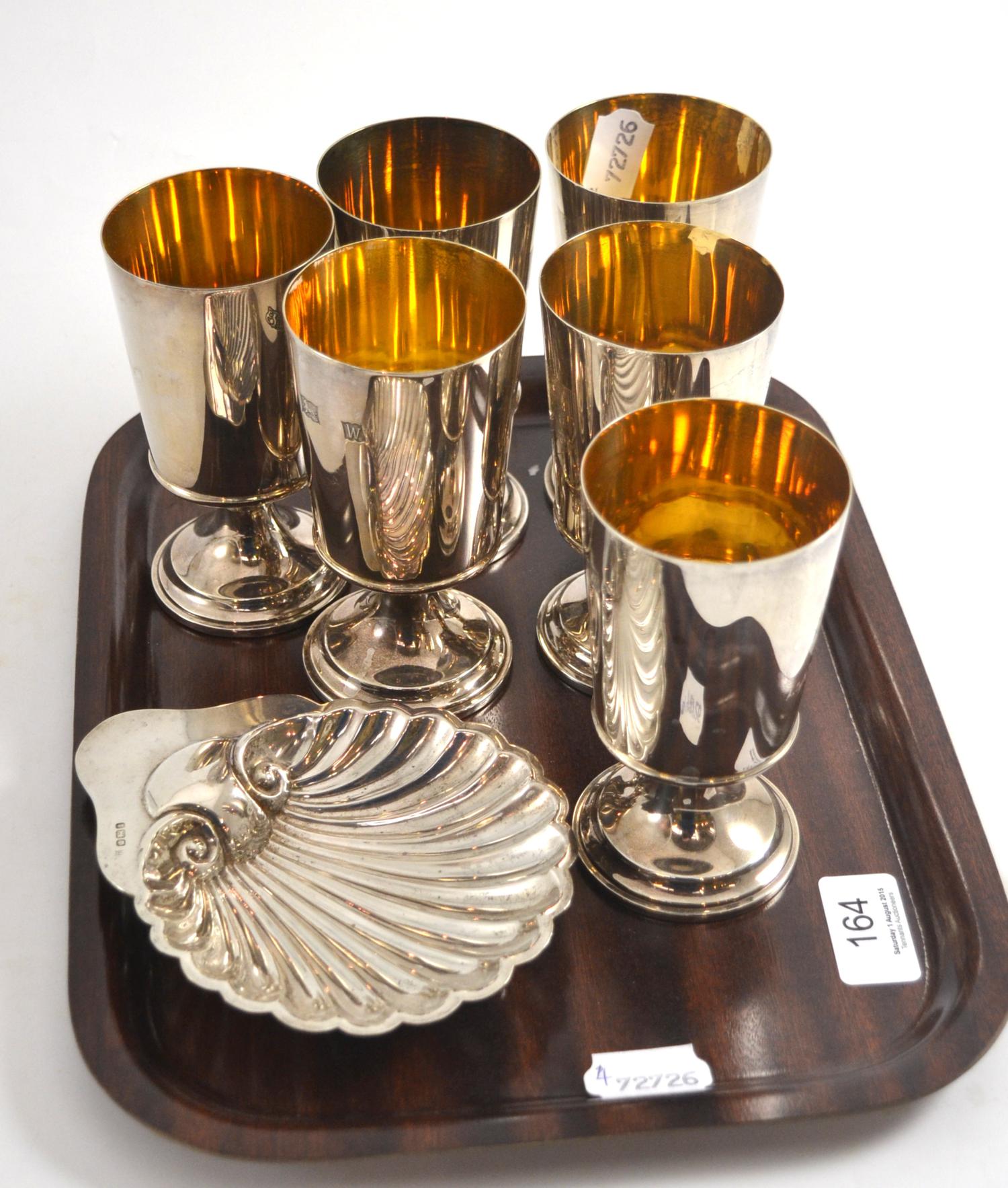 A set of six silver goblets and a silver shell dish 30.68ozt gross