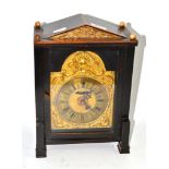 An oak cased mantel clock with brass dial
