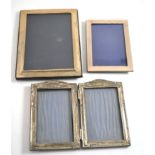 A hinged silver double photograph frame and two other silver mounted frames