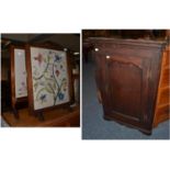 Georgian oak corner cupboard and two firescreens with embroidered inserts (3)