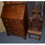 A narrow oak bureau, a corner cupboard carved with a dead snipe and a hall chair with a mermaid