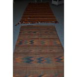 Afghan Kilim, the madder field with polychrome turreted bands, 257cm by 157cm; and a Balouch