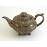 A George IV Silver Teapot, Hyam Hyams, London 1823, the compressed body embossed with flowers,