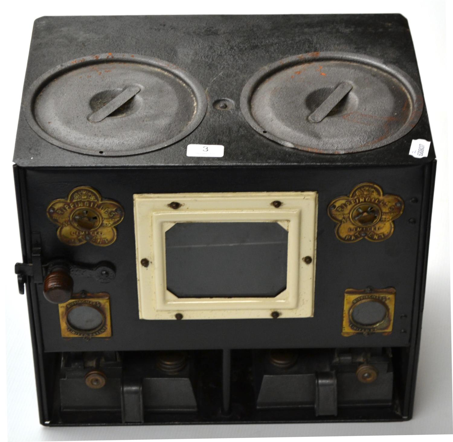 A Rippingilles Patent No.630 Portable Stove, with black tinplate body, twin hobs, hinged door,