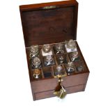 Apothecary Chest mahogany case with brass fitting; 13 slots with 12 glass bottles in top and a lower