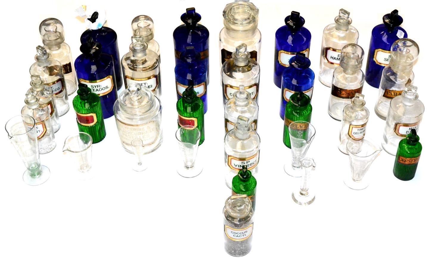 Pharmaceutical Jars a collection of assorted glass jars in cobalt blue, green and clear, most with