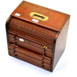 Cased Set Of Dental Instruments in six drawer mahogany chest with lockable roller cover concealing a