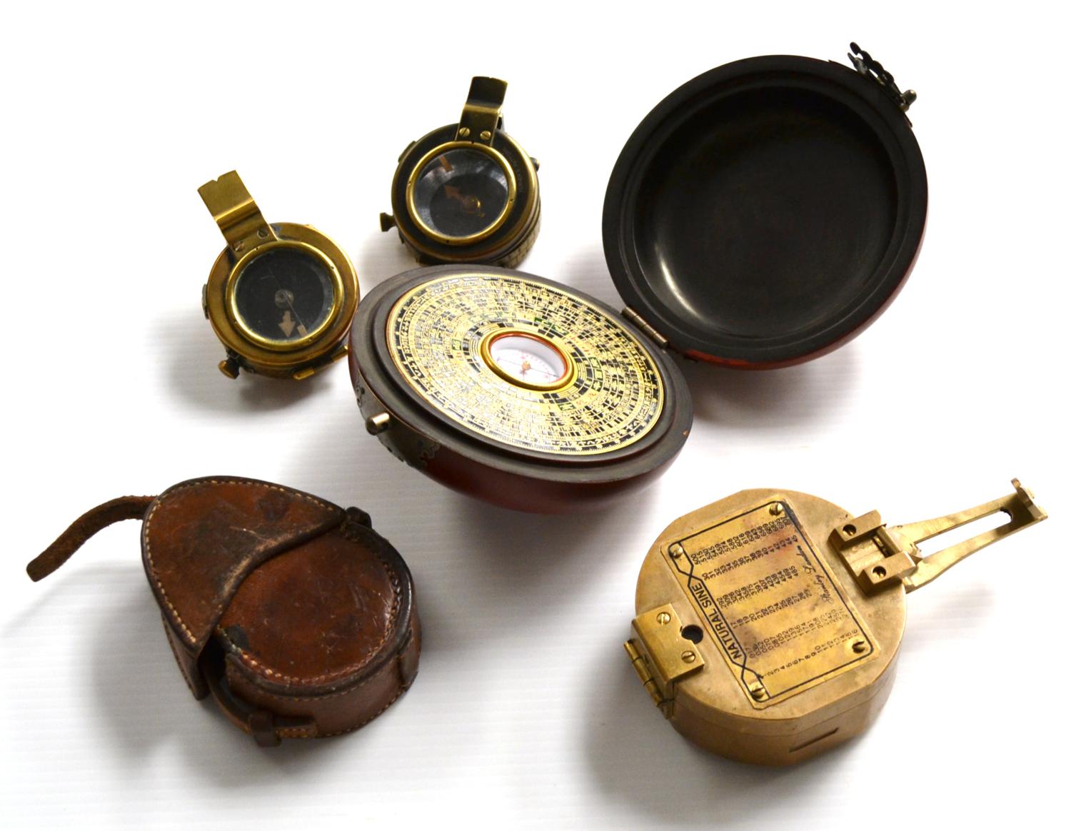 Three Sighting Compasses (i) Stanley with twin levels and Natural Sine Table (ii) Glauser Mk IX