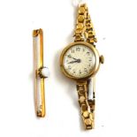 A 9ct gold lady's wristwatch and an opal bar brooch stamped '15C'