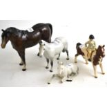 Beswick girl on pony and three Beswick horses