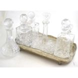 A group of six decanters and a silver plated tray