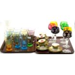 A set of sixteen coloured glass tumblers, seven coloured hock glasses and six coffee cups and