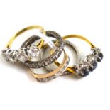 Five rings comprising of a platinum and diamond eternity ring, an 18ct gold diamond and sapphire