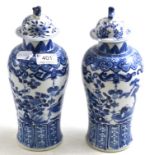 A pair of 19th century Chinese blue and white vases and associated covers, 29cm high  Vase 1 - the