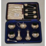 A cased set of silver coffee spoons together with a cased silver condiment set