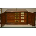 An oak four-drawer cutlery canteen, containing an extensive flatware service