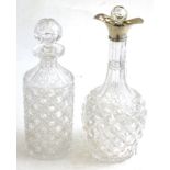 A silver mounted double lipped decanter and a cylindrical cut glass decanter (2)