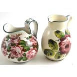 Two Wemyss jugs, rose pattern  Larger - heavily crazed throughout, 18cm high. Other - lightly