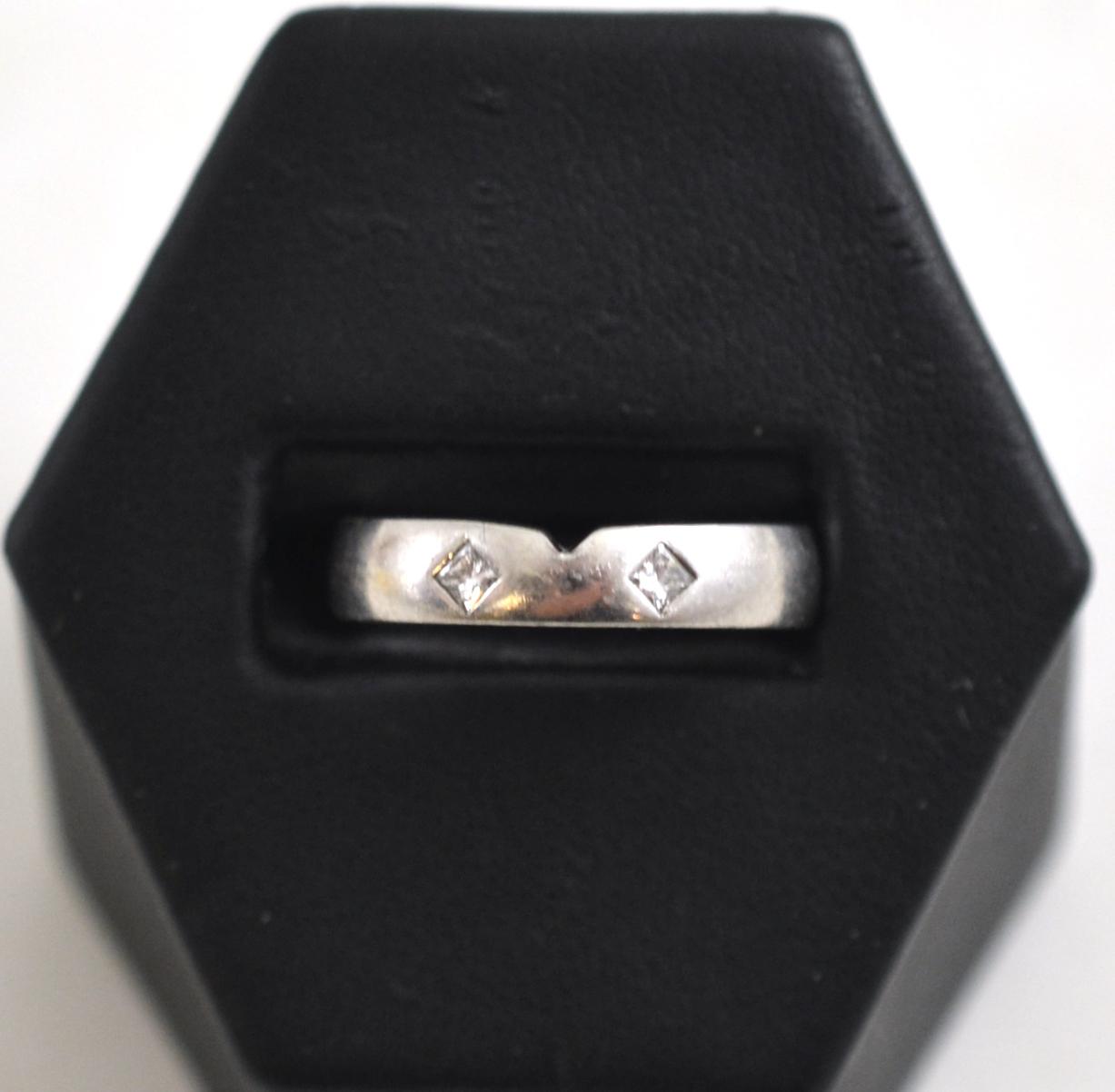 A platinum and diamond band ring