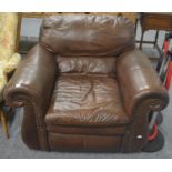 A modern brown leather armchair