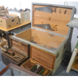 A large wooden carpenters tool box and a collection of wood working tools including chisels, saws,