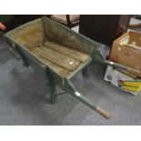 A green painted wooden wheel barrow