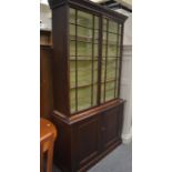 A pine Victorian astragal glazed bookcase on cabinet