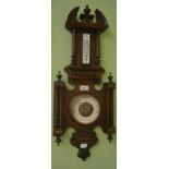 A carved oak barometer