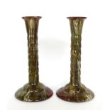 1927 A Pair of Linthorpe Pottery Candlesticks, green and white runny glaze, on a brown ground,