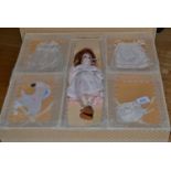 Bisque socket head Belton type doll in presentation box, with brown wig, fixed brown eyes, pierced
