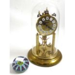 Clock under dome and a glass paperweight