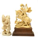 A 19th century Japanese carved ivory figure of a fisherman and another of St George and the Dragon