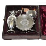 A cased silver Communion set comprising chalice, paten, ewer and a stopper (different maker to the