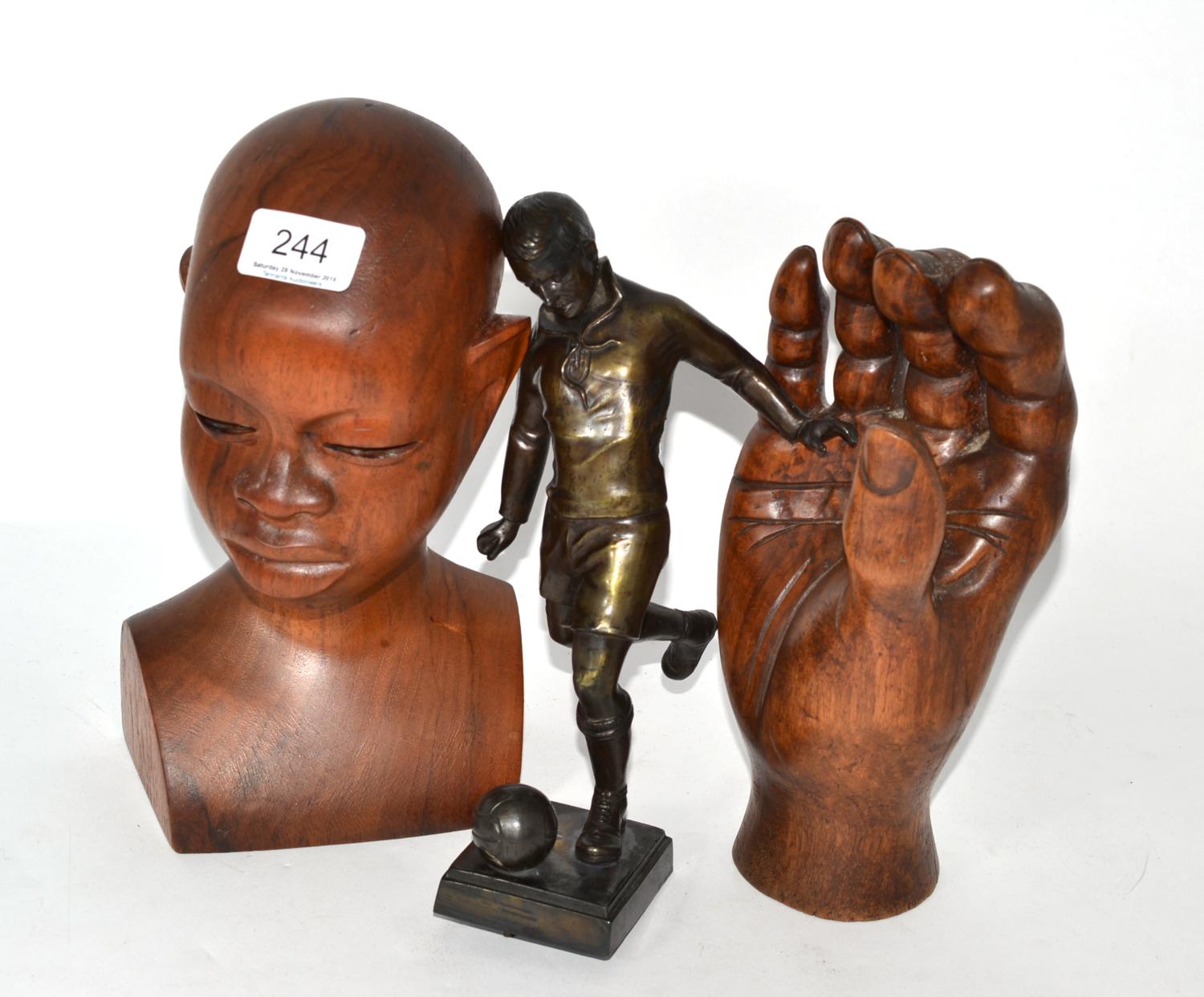 A bronze statue of a footballer monogrammed to base KM, together with a wooden bust signed and dated