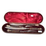 A four piece cased antler handled carving set by Joseph Rodgers & Sons